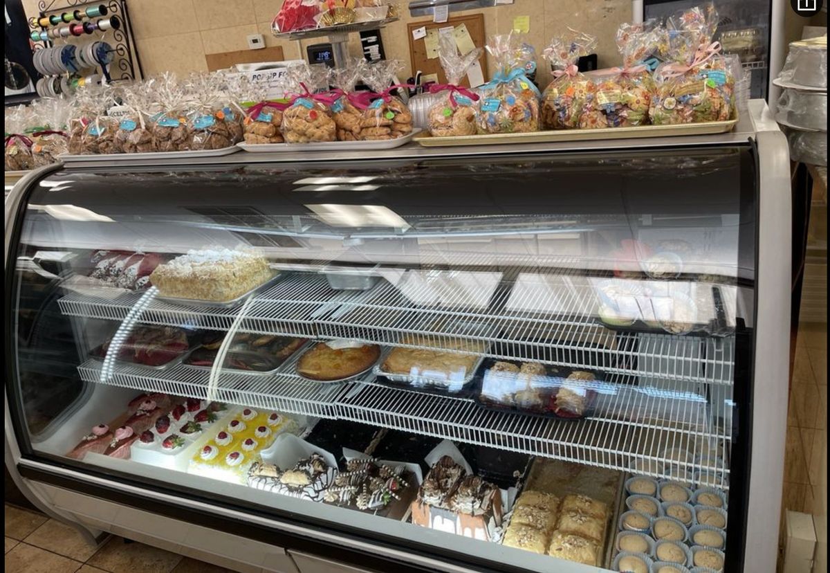 Bakery display case full of pastries and cookies
