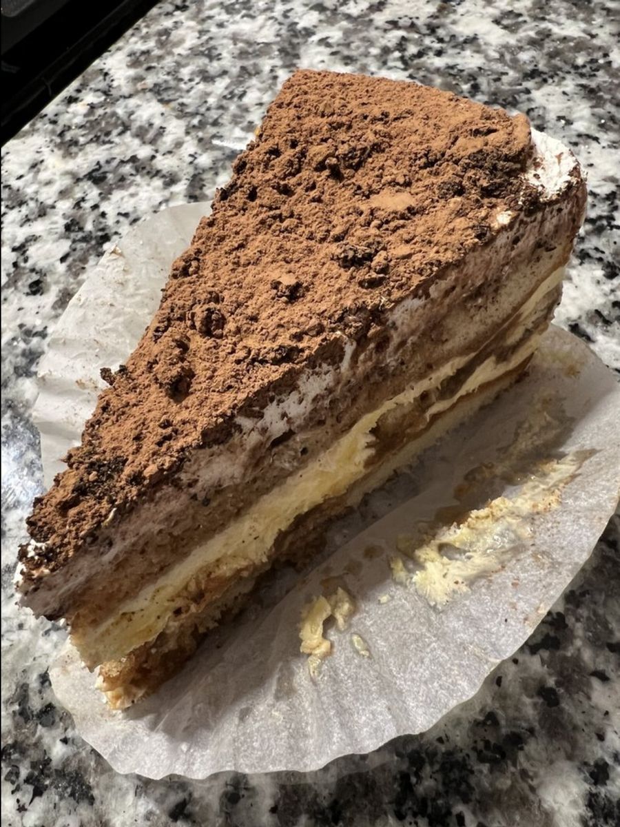 Cocoa-dusted European layer cake slice