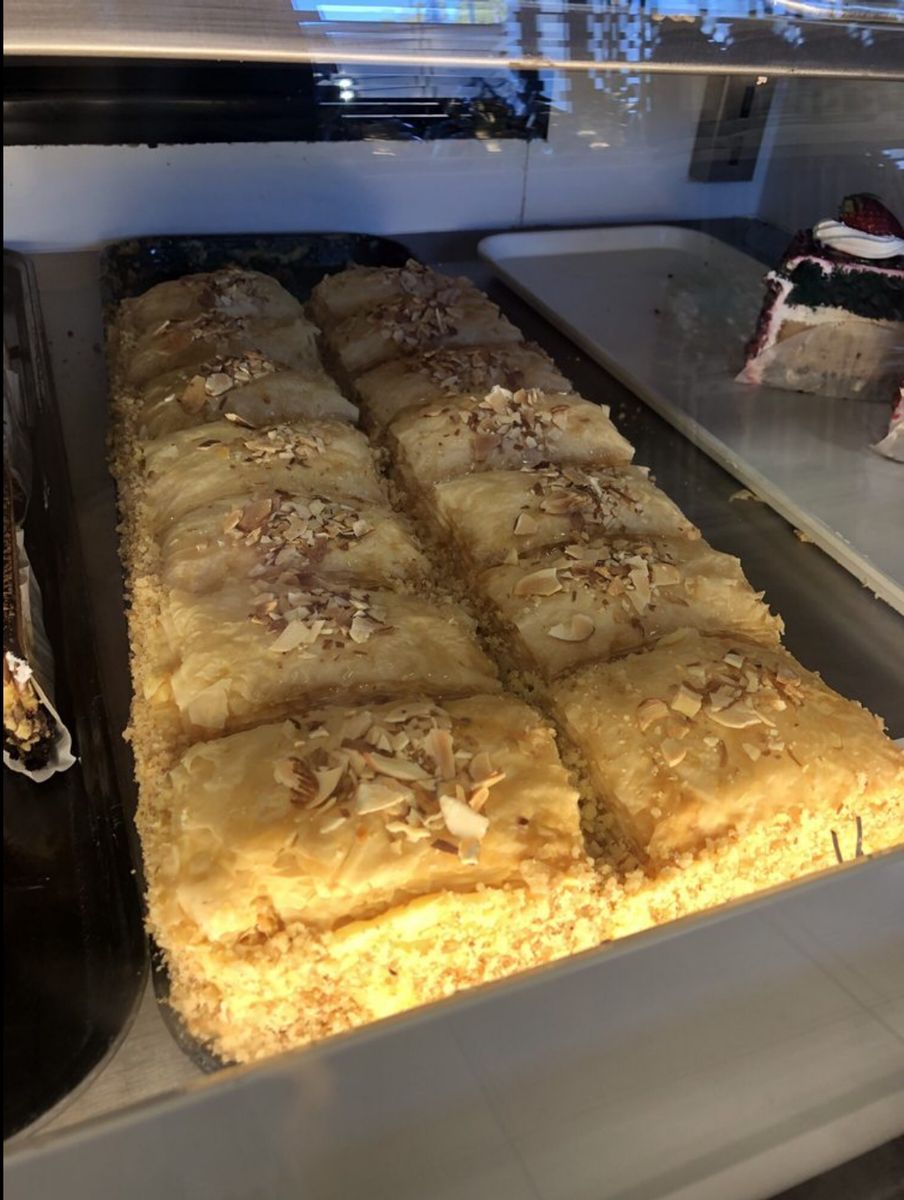 Tray of golden galaktoboureko topped with almonds